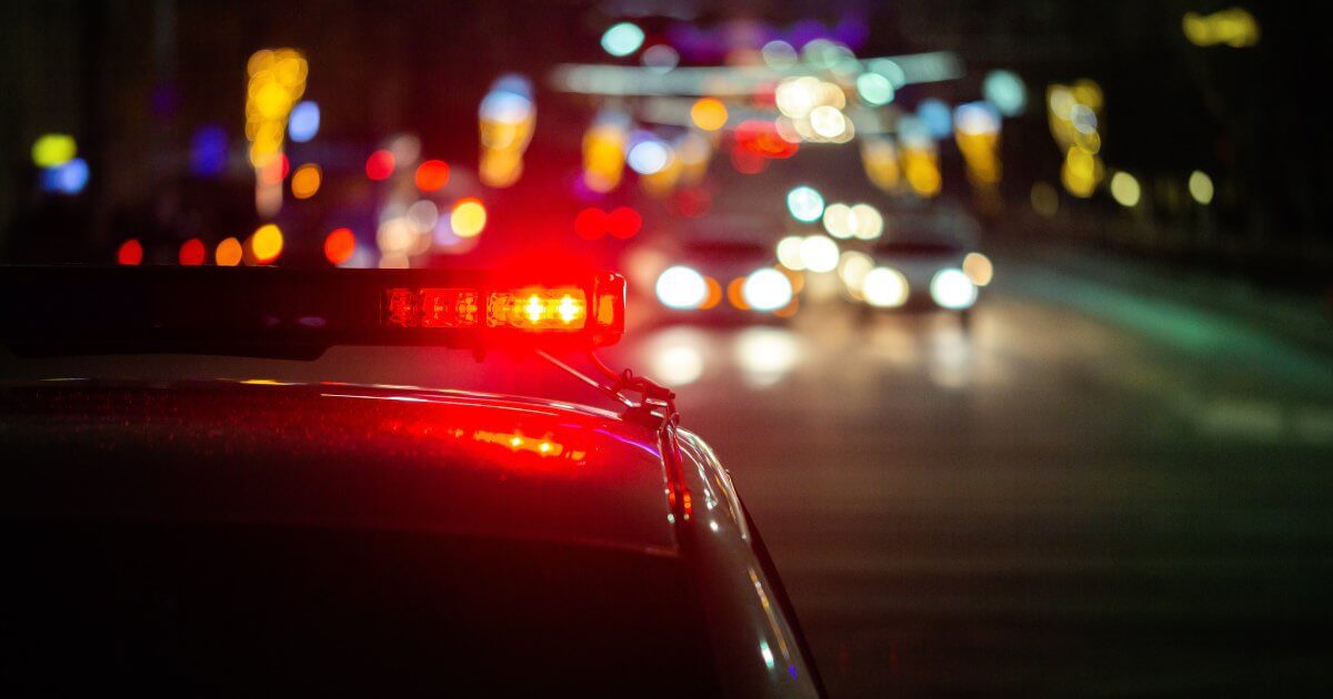 red light flashing on police car at night