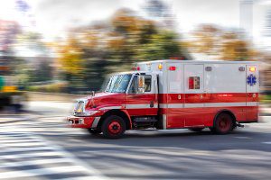 ambulance on road during sunny day