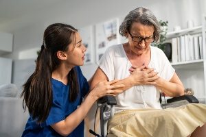 middle-aged woman holding her chest in pain after car crash